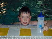 Swimmer Robbie Anderson grabs his water bottle after a length of the pool | NI Water News